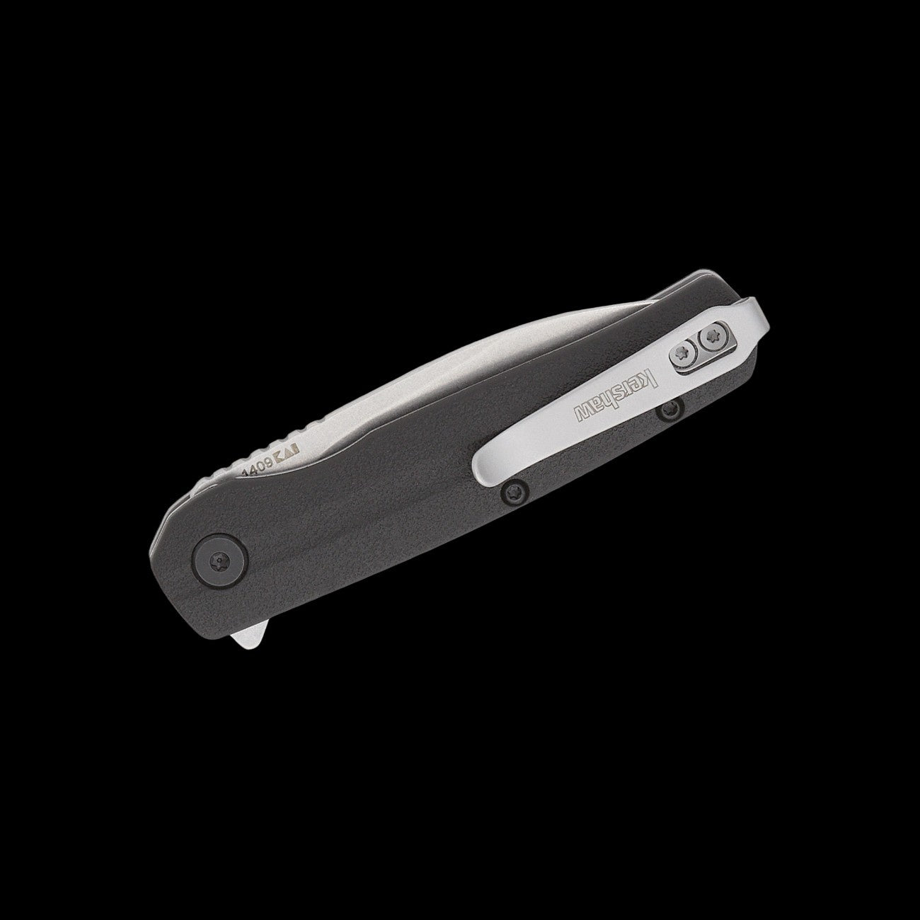 A folding pocket knife with a dark gray textured handle and a silver clip-point blade, shown open against a solid black background. The brand name 'Kershaw' is visible on the pocket clip.