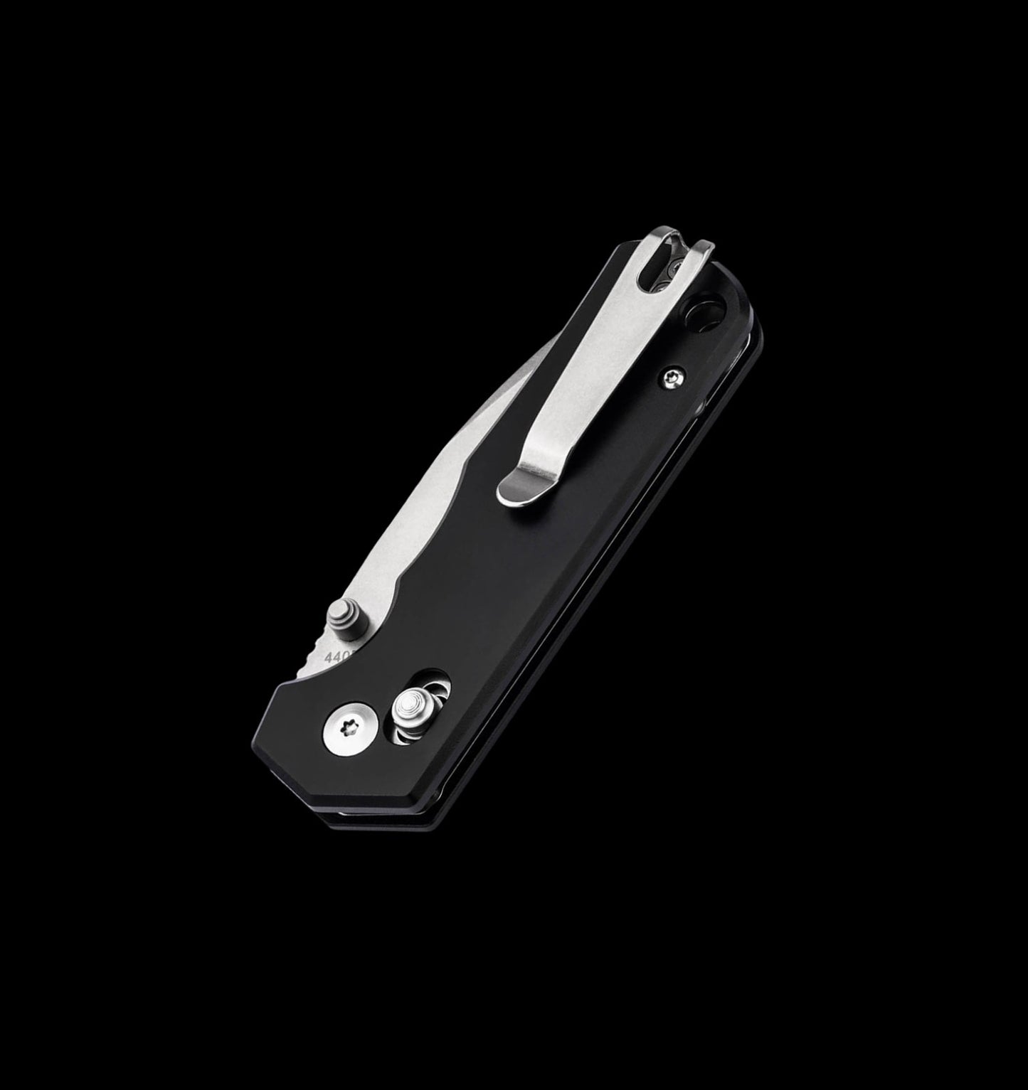 A black folding pocket knife with a silver clip point blade, shown partially open against a solid black background.