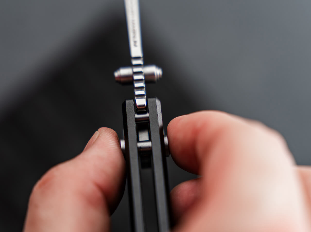 Close-up of a hand holding a pocket knife with a blurred background