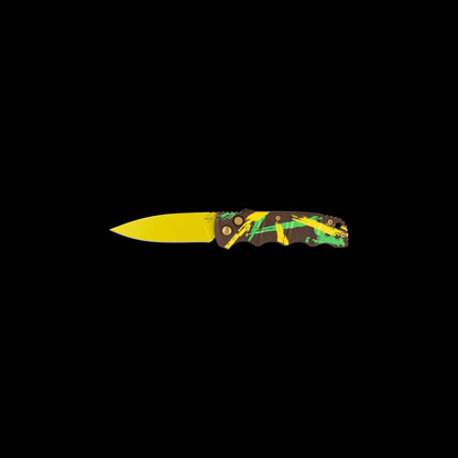 A folding pocket knife with a bright yellow blade and a handle featuring a green, yellow, and black camouflage pattern, shown against a solid black background.
