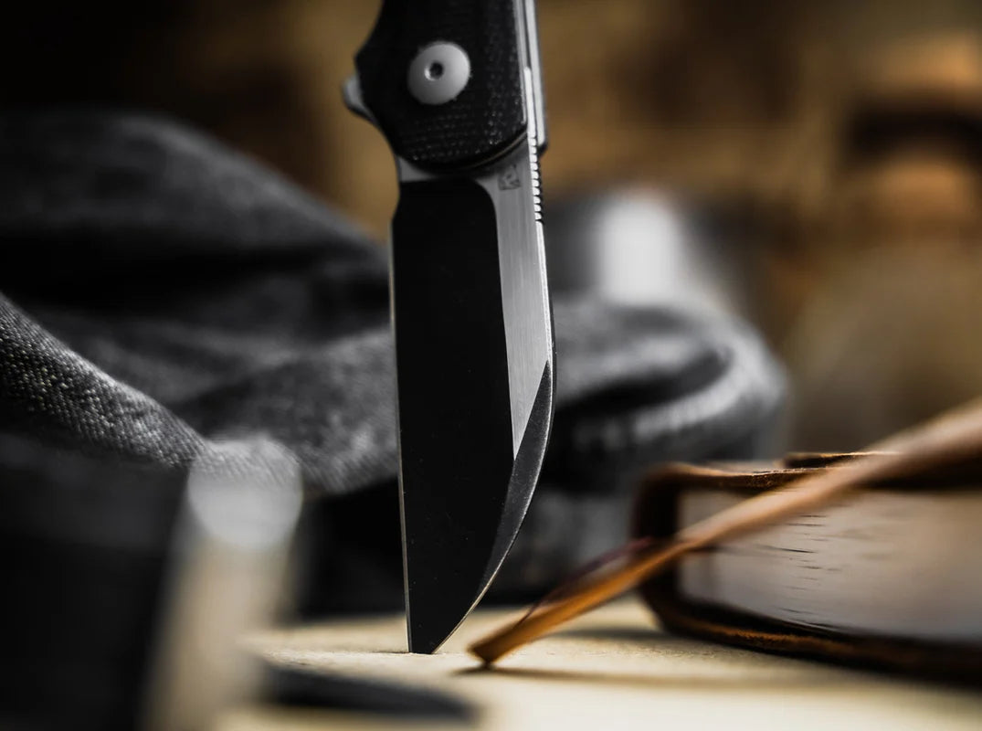 Folding knife on a wooden surface with a blurred background