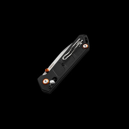 A black folding pocket knife with a textured handle, silver clip point blade, and orange accent screws, shown open against a solid black background.