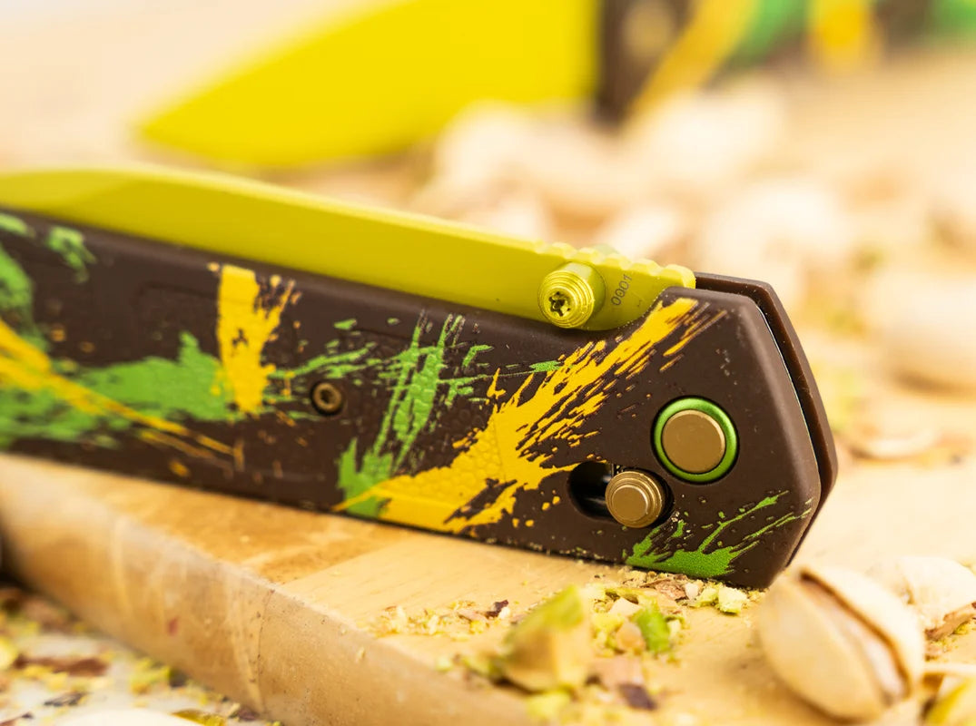 Folding saw with a colorful handle on a wooden surface