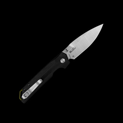 A folding pocket knife with a satin-finished silver blade and a textured black handle, shown open against a solid black background. The brand 'Kershaw' is visible on the blade.