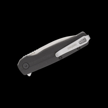 A folding pocket knife with a dark gray textured handle and a silver clip-point blade, shown open against a solid black background. The brand name 'Kershaw' is visible on the pocket clip.