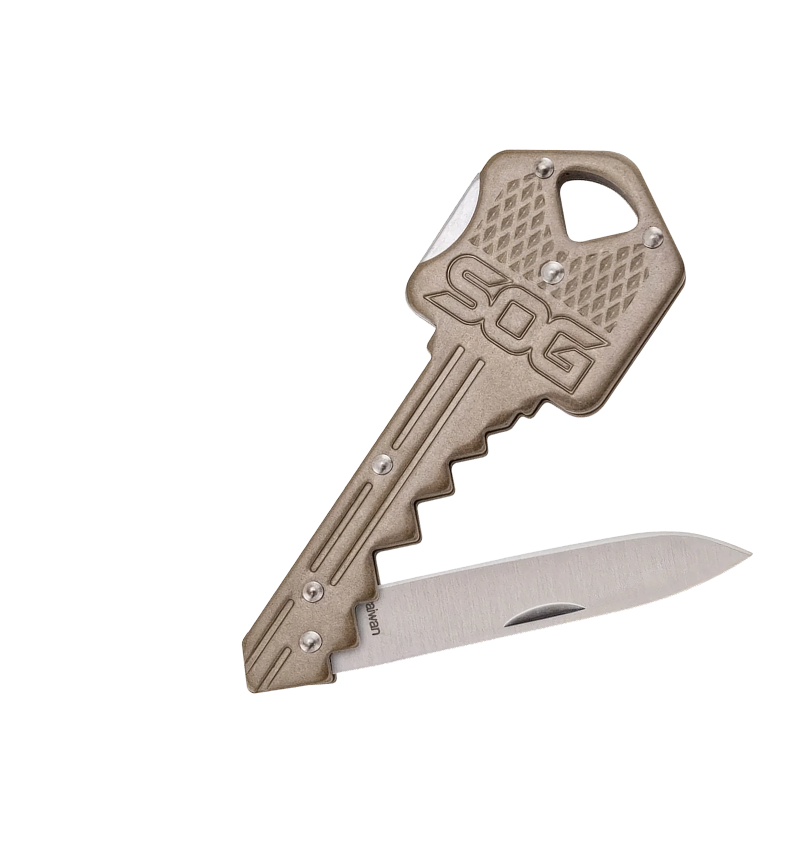 A 5.06 caliber key-shaped folding pocket knife with a textured tan metal head and a silver stainless steel blade, shown open on a white background.
